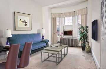 Brookline apartment for rent - a living room with a blue couch and a coffee table